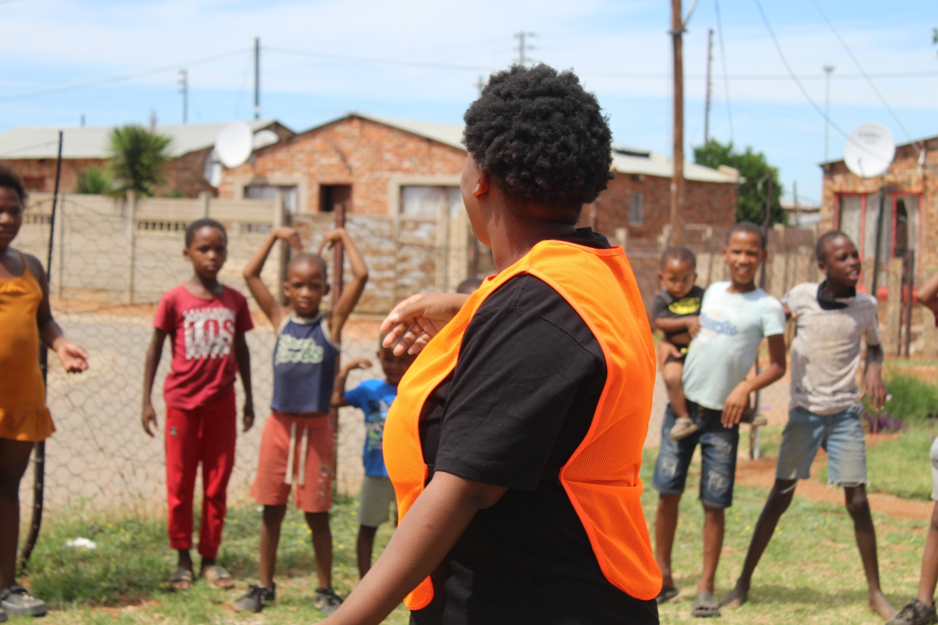 Come N Play facilitator leading a community Play Park session with children outside