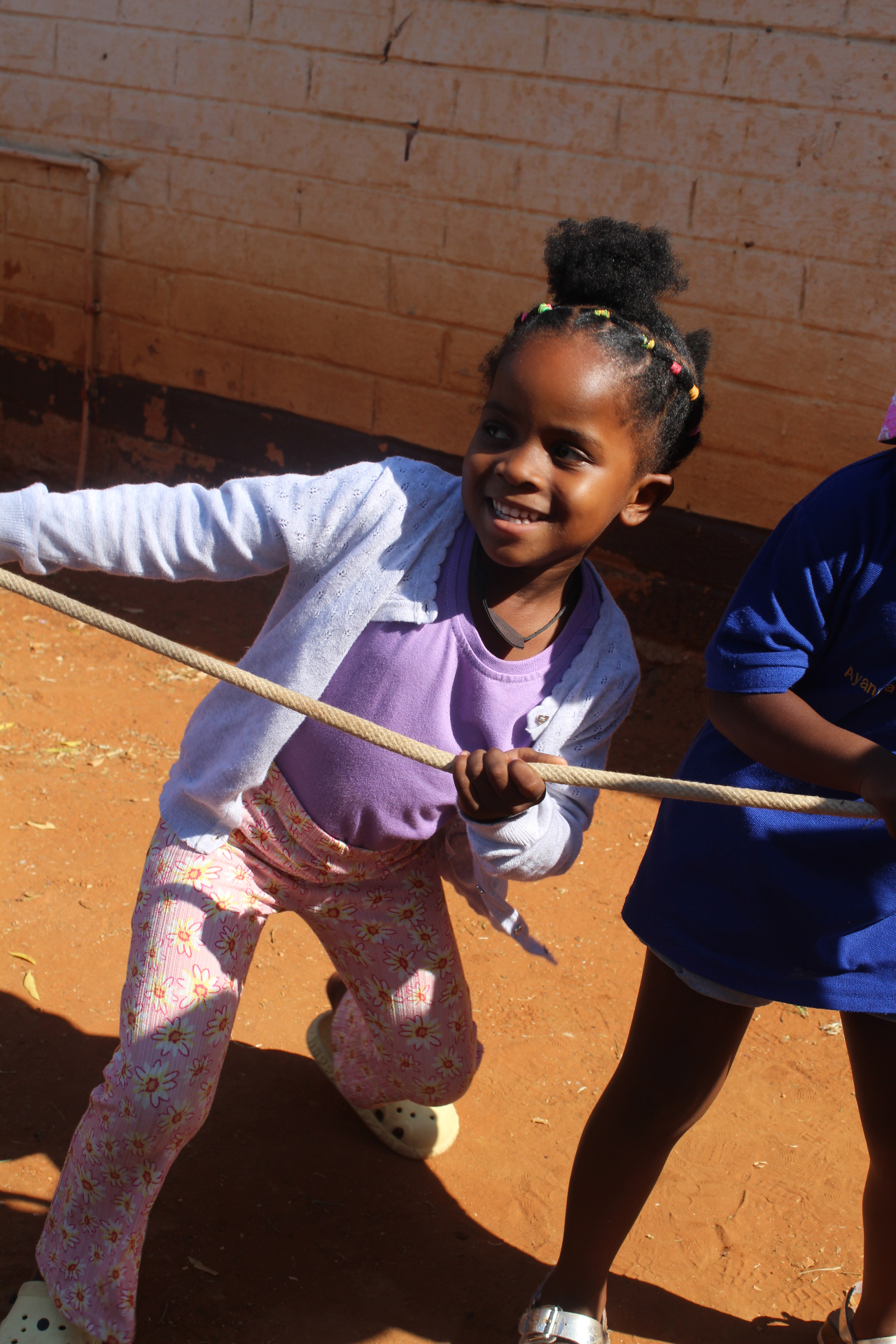 Children pulling a rope during a tug-of-war activity